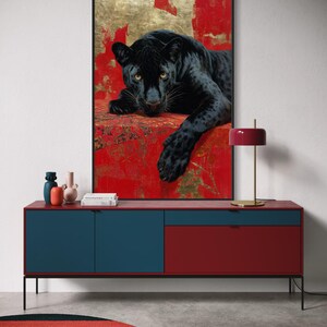 Striking art print of a black panther resting against a rich red and gold abstract background. The panther’s piercing gaze, sleek dark fur, and powerful presence create a dramatic and luxurious statement piece, blending wildlife majesty with bold modern art design for a captivating interior accent.