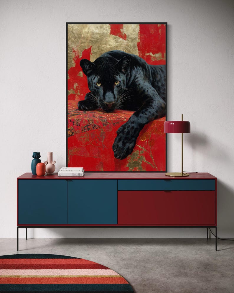 Striking art print of a black panther resting against a rich red and gold abstract background. The panther’s piercing gaze, sleek dark fur, and powerful presence create a dramatic and luxurious statement piece, blending wildlife majesty with bold modern art design for a captivating interior accent.