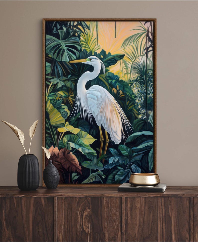 This canvas print captures a majestic heron standing amidst lush tropical foliage, illuminated by a soft, golden sunrise. Its detailed portrayal and vibrant setting make it a striking piece for any nature or bird enthusiast's collection.