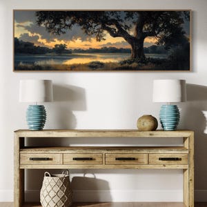 Capturing the tranquil essence of dusk, this panoramic artwork features a majestic oak tree overlooking a serene river, illuminated by the golden hues of a setting sun.