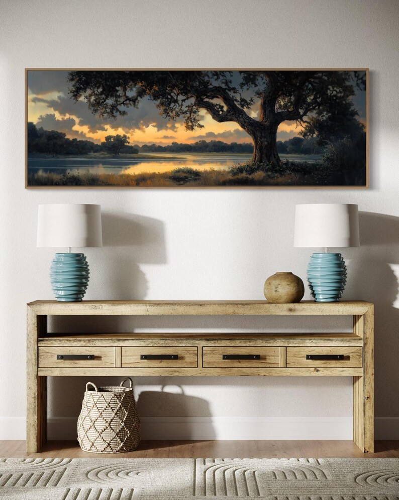 Capturing the tranquil essence of dusk, this panoramic artwork features a majestic oak tree overlooking a serene river, illuminated by the golden hues of a setting sun.