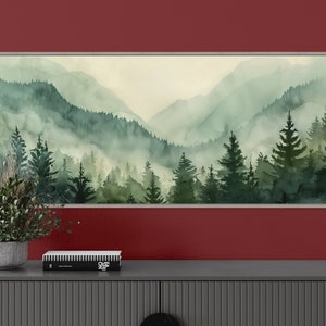 Misty Mountain Serenity: A dreamy vista where lush evergreens pierce through the soft veil of morning mist, creating layers of tranquil beauty.