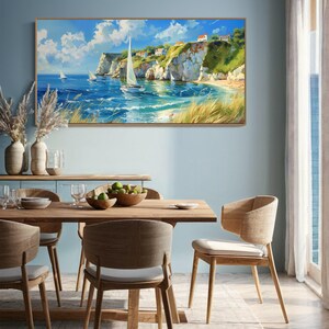 Sailboats glide on azure waters near chalky cliffs with green tops under a vast, cloud-dappled sky, portraying a serene, sunlit seascape.