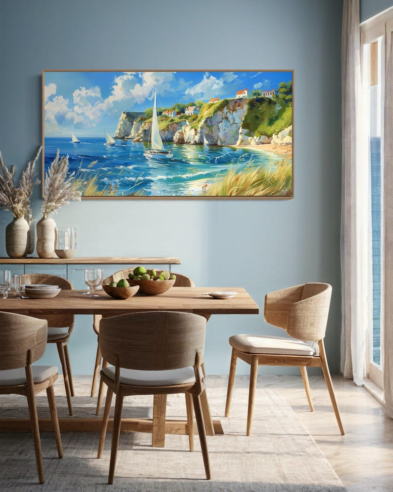 Sailboats glide on azure waters near chalky cliffs with green tops under a vast, cloud-dappled sky, portraying a serene, sunlit seascape.