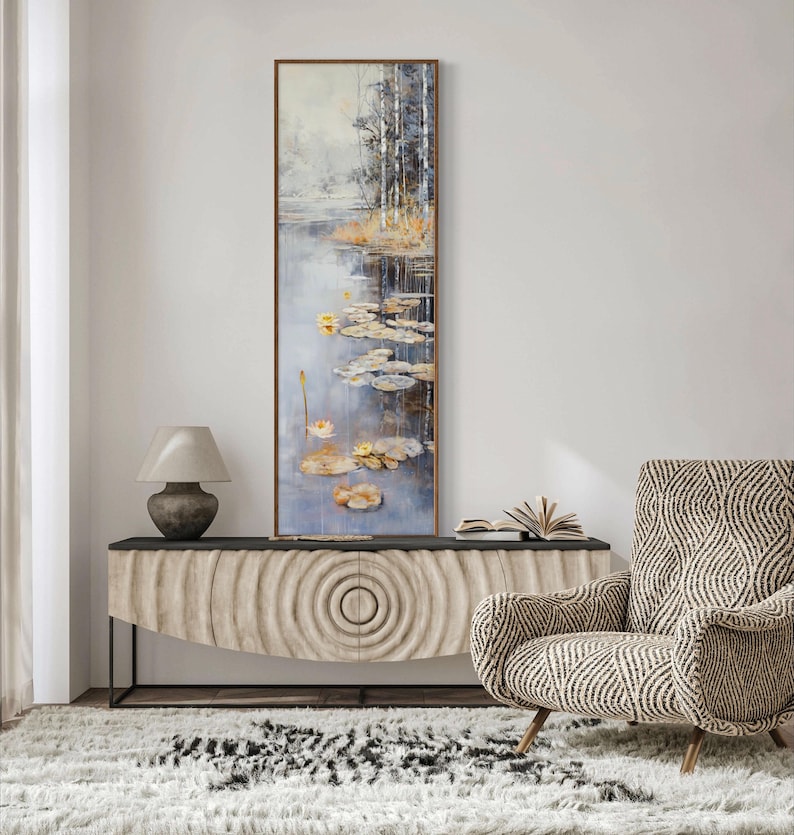This serene painting features a tranquil pond with lily pads and birch trees. The soft, muted colors and delicate details create a peaceful, reflective scene, perfect for adding a touch of nature and calm to any space.