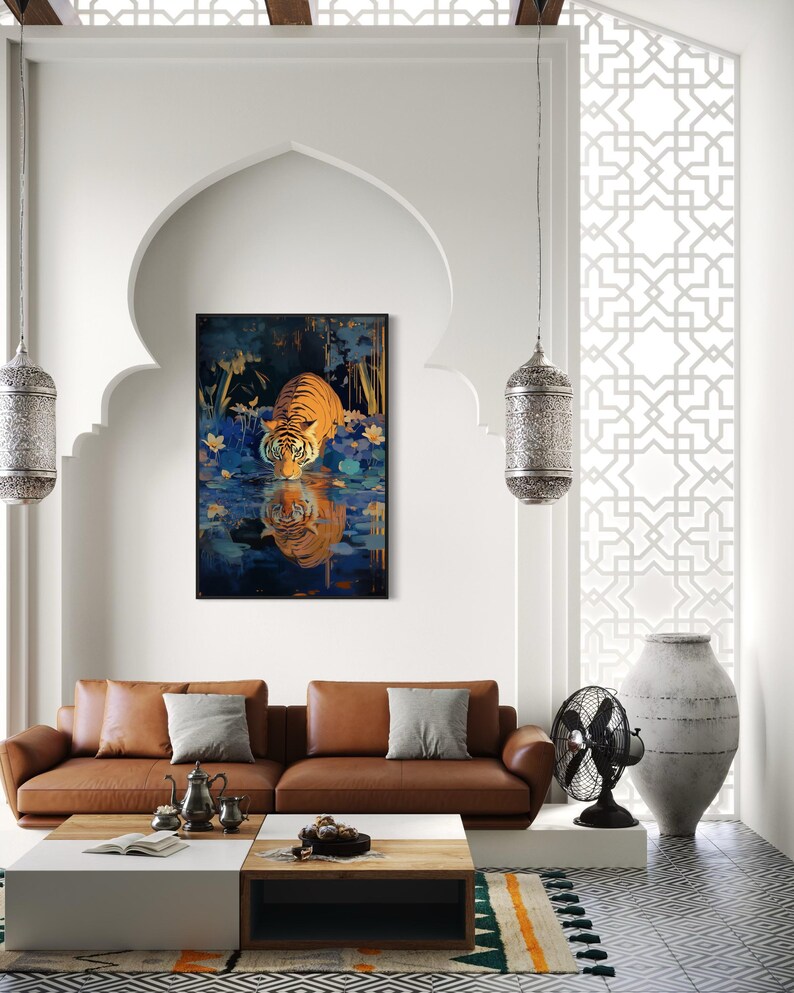 A majestic tiger drinks from a calm lake, its reflection glowing in golden hues. Surrounded by blue flowers and soft light, this art print blends nature with elegance, perfect for boho, nature, or wildlife-themed home decor.