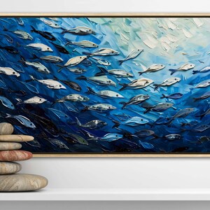 A dynamic school of fish swims in unison through the tranquil blue sea, their silvery scales reflecting light, depicted with thick, textured brushstrokes that give life and movement to this captivating marine scene.
