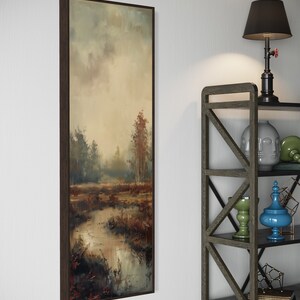 This atmospheric painting captures a moody landscape with a dramatic interplay of light and shadow. A muted palette conveys the serenity of a misty marshland, evoking a sense of quiet introspection.