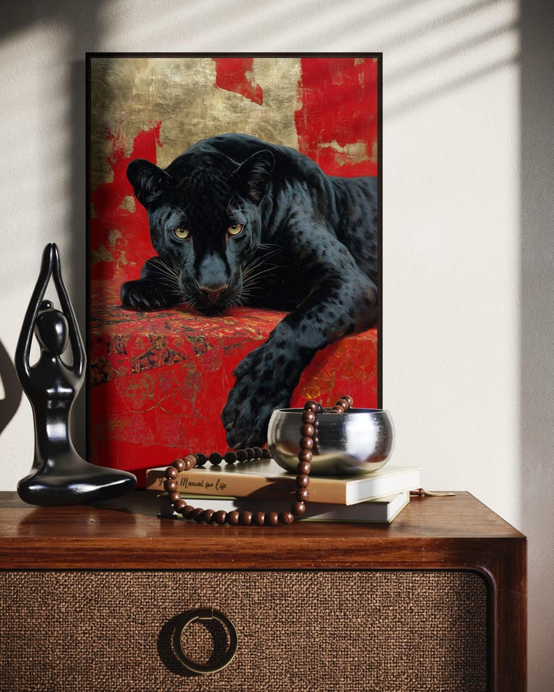 Striking art print of a black panther resting against a rich red and gold abstract background. The panther’s piercing gaze, sleek dark fur, and powerful presence create a dramatic and luxurious statement piece, blending wildlife majesty with bold modern art design for a captivating interior accent.