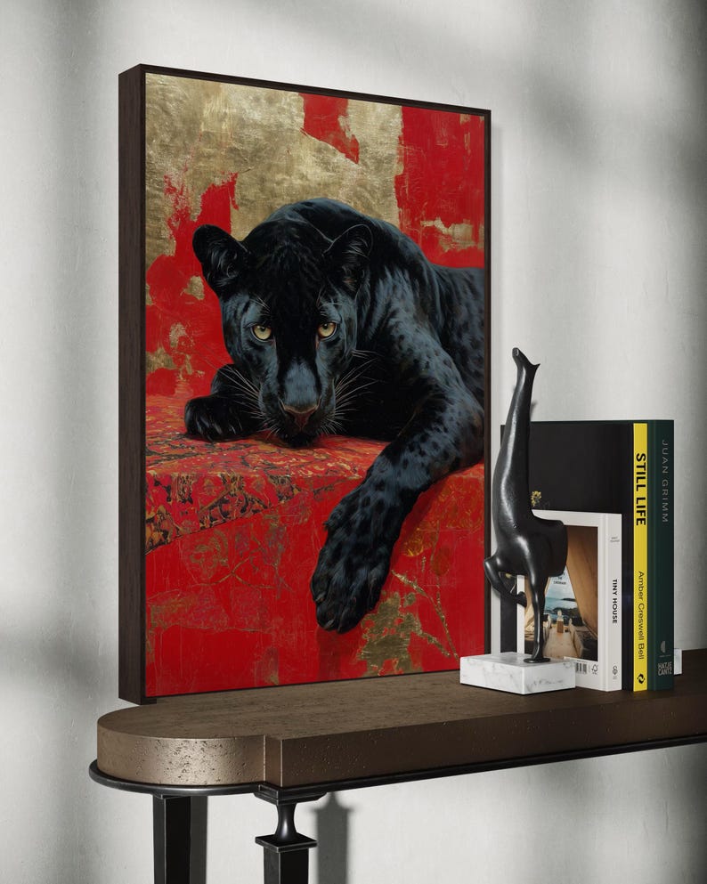 Striking art print of a black panther resting against a rich red and gold abstract background. The panther’s piercing gaze, sleek dark fur, and powerful presence create a dramatic and luxurious statement piece, blending wildlife majesty with bold modern art design for a captivating interior accent.
