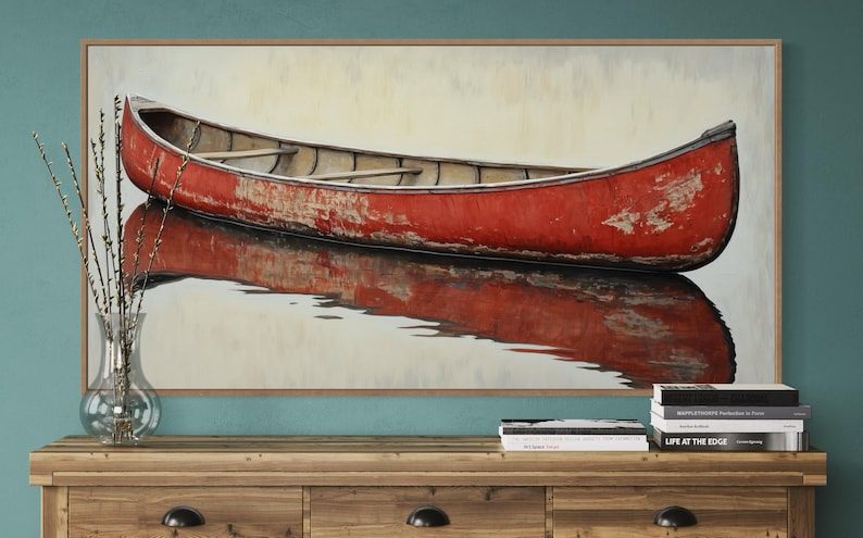 This artwork features a rustic red canoe resting serenely on calm waters. The canoe, with its weathered surface, reflects beautifully in the water, showcasing its rich color. The soft background adds a tranquil atmosphere, perfect for nature lovers.