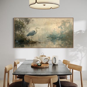 A serene heron stands amidst a tranquil swamp, reflected in the calm waters, set against a backdrop of ethereal, golden-hued trees and a soft, diffuse light that permeates this peaceful landscape painting.