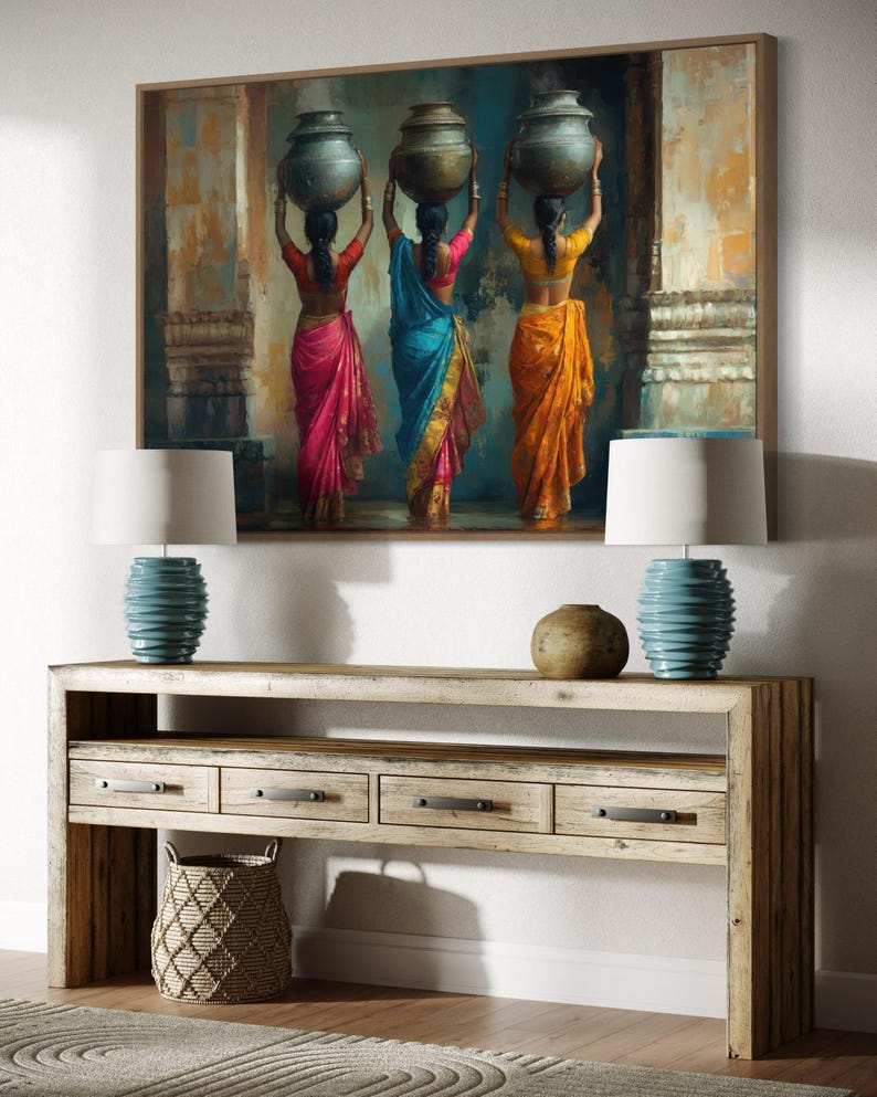 Celebrate cultural beauty with this vibrant art piece depicting three Indian women in colorful saris, gracefully carrying pots on their heads. The rich textures and warm tones make it a stunning addition to any space.
