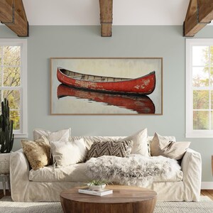 This artwork features a rustic red canoe resting serenely on calm waters. The canoe, with its weathered surface, reflects beautifully in the water, showcasing its rich color. The soft background adds a tranquil atmosphere, perfect for nature lovers.