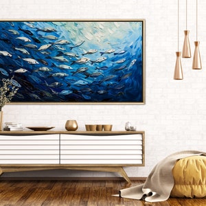 A dynamic school of fish swims in unison through the tranquil blue sea, their silvery scales reflecting light, depicted with thick, textured brushstrokes that give life and movement to this captivating marine scene.