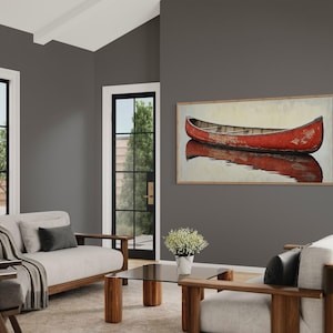 This artwork features a rustic red canoe resting serenely on calm waters. The canoe, with its weathered surface, reflects beautifully in the water, showcasing its rich color. The soft background adds a tranquil atmosphere, perfect for nature lovers.