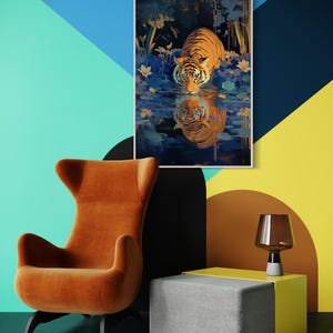 A majestic tiger drinks from a calm lake, its reflection glowing in golden hues. Surrounded by blue flowers and soft light, this art print blends nature with elegance, perfect for boho, nature, or wildlife-themed home decor.