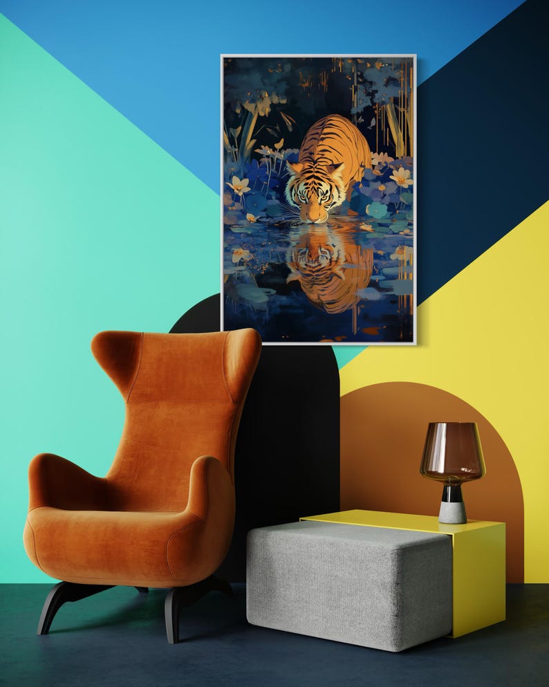 A majestic tiger drinks from a calm lake, its reflection glowing in golden hues. Surrounded by blue flowers and soft light, this art print blends nature with elegance, perfect for boho, nature, or wildlife-themed home decor.