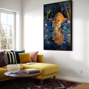 A majestic tiger drinks from a calm lake, its reflection glowing in golden hues. Surrounded by blue flowers and soft light, this art print blends nature with elegance, perfect for boho, nature, or wildlife-themed home decor.