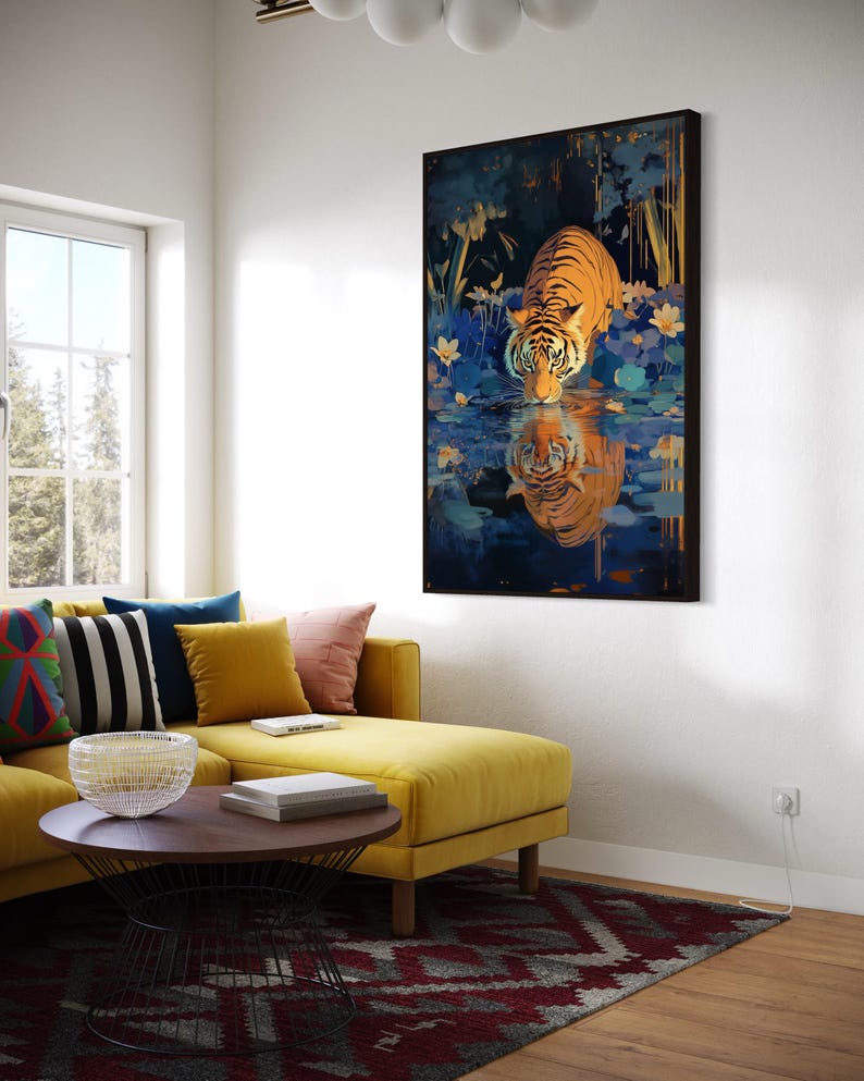 A majestic tiger drinks from a calm lake, its reflection glowing in golden hues. Surrounded by blue flowers and soft light, this art print blends nature with elegance, perfect for boho, nature, or wildlife-themed home decor.