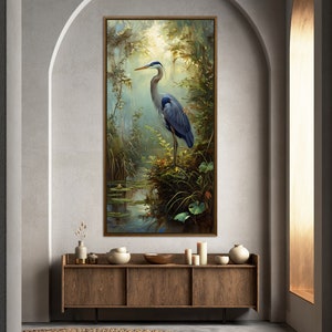 A serene Blue Heron stands amidst a lush wetland oasis, its graceful form bathed in dappled sunlight filtering through a verdant canopy. Perfect for a tranquil decor piece.
