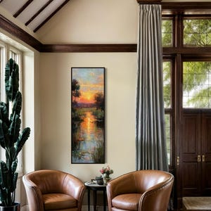 Impressionist landscape art of a glowing sunset over a peaceful waterway with lily pads and tall grasses. The golden light reflects on the calm water, surrounded by soft trees and vibrant colors. A serene nature scene perfect for rustic, cottage, or lake house decor.