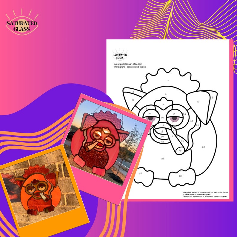 May include: A color-by-number pattern of a cartoon Furby with a cigarette in its mouth. The pattern is numbered 1-39. The image also shows two completed stained glass versions of the Furby, one in pink and one in orange.