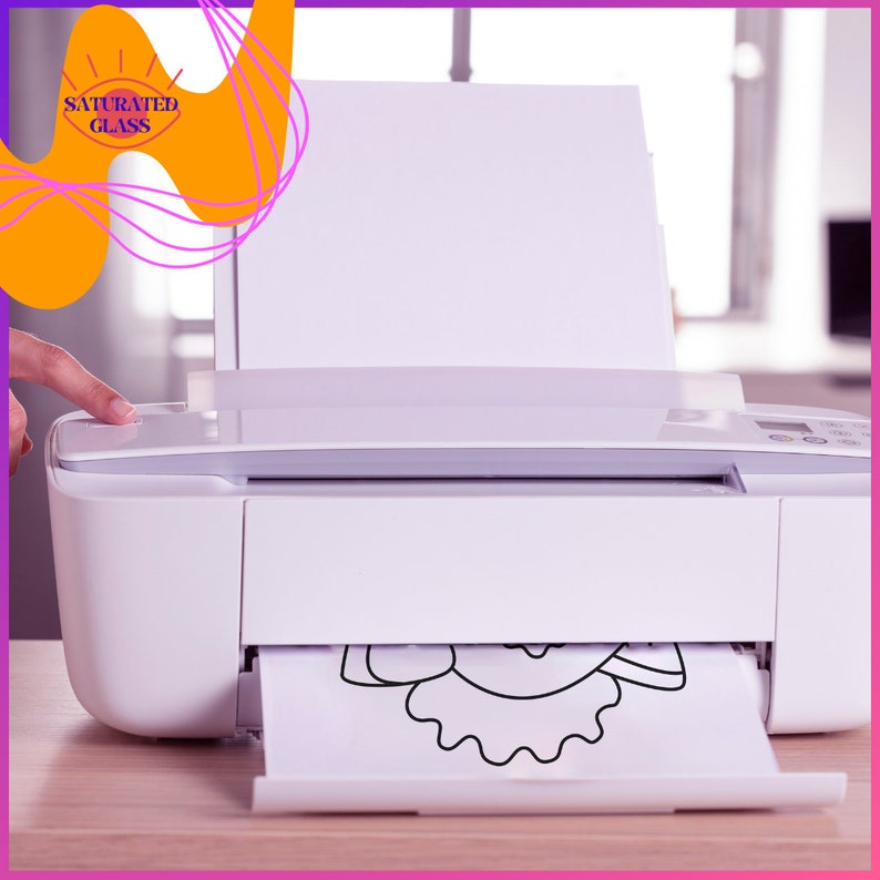 May include: A white printer with a sheet of paper coming out of the tray. The paper has a black and white line drawing of a flower on it.
