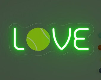 May include: Green neon sign with the word "LOVE" and a tennis ball in the center. The sign is on a wall with a crib and a deer figurine in the background.