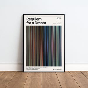 May include: A framed film poster for Requiem for a Dream from 2000, directed by Darren Aronofsky. The design features a central vertical colour palette of thin stripes in shades of blue, brown, black, and grey, with white text detailing the film credits.