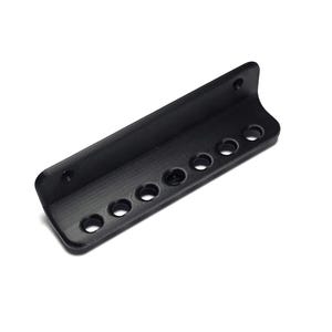 May include: A matte black L-shaped mounting bracket featuring a long horizontal base with seven evenly spaced circular holes and a vertical back plate with two smaller circular holes for attachment, constructed with a textured finish.