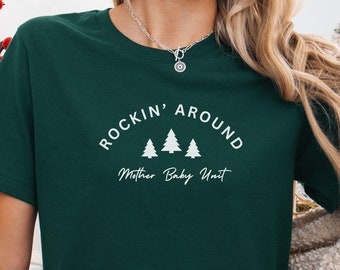 May include: A green t-shirt with the text "Rockin' Around Mother Baby Unit" and three white stylized Christmas trees.