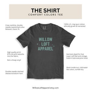 May include: Dark gray Comfort Colors tee shirt with the text "WILLOW LOFT APPAREL" in light blue. The shirt has a crew neckline, double-needle stitching, and is made of 100% ring-spun cotton. The shirt is garment-dyed for a soft, vintage look.