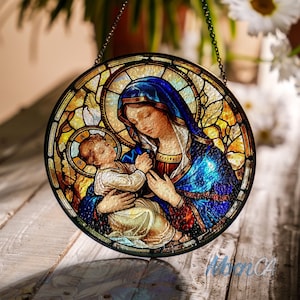 May include: A stained glass window depicting the Virgin Mary holding the baby Jesus. The image is set against a background of yellow and blue stained glass.