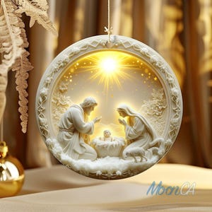 May include: A white, circular Christmas ornament depicting the Nativity scene. The ornament features Joseph, Mary, and baby Jesus, with a bright light emanating from behind them. The ornament is trimmed with floral designs and a hanging string.