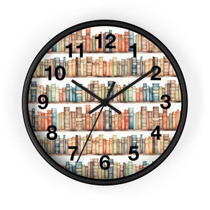 May include: A black framed clock with a white background and a bookshelf design. The clock face features Roman numerals and black hands. The bookshelf is filled with colorful books.