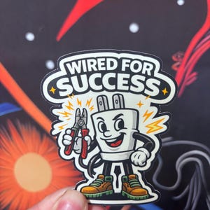 May include: A sticker featuring a cartoon plug character holding pliers, with the text "WIRED FOR SUCCESS" in a white and black design. The plug has a smiling face, wearing brown and orange shoes, and is surrounded by yellow lightning bolts.