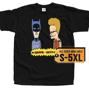May include: Black t-shirt featuring a cartoon image of Batman and Beavis from the MTV show Beavis and Butt-Head. The text "Beavis and Butt-Head" is printed below the image. The t-shirt is available in sizes S-5XL.