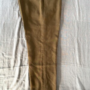 May include: A pair of brown dress pants with a straight leg fit.