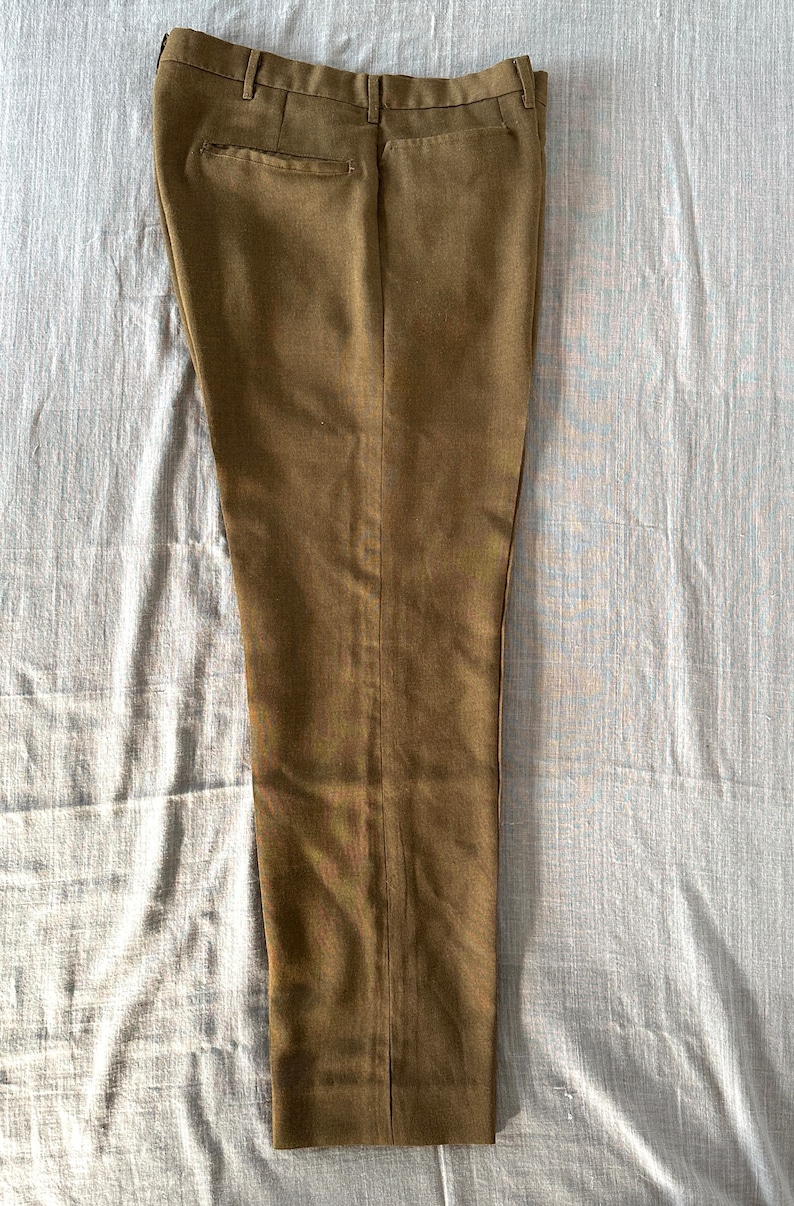 May include: A pair of brown dress pants with a straight leg fit.