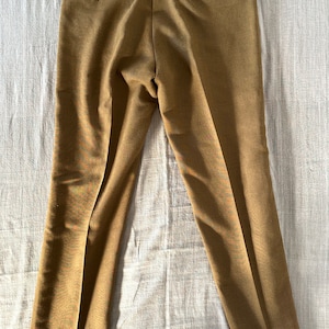 May include: A pair of brown straight-leg pants with a button fly and a back pocket.