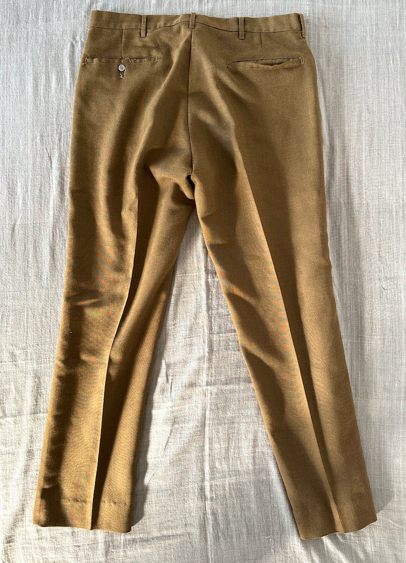 May include: A pair of brown straight-leg pants with a button fly and a back pocket.