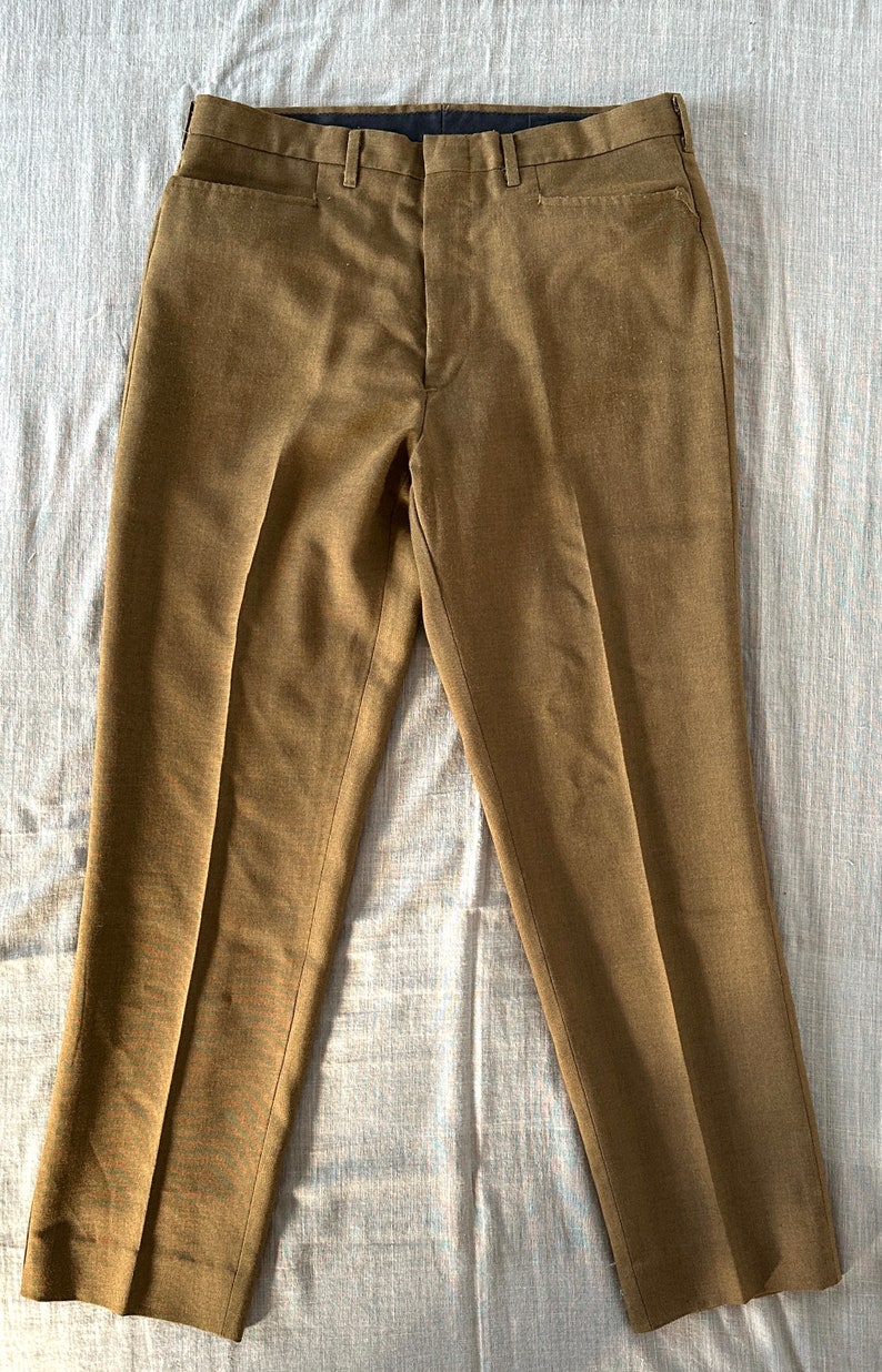 May include: A pair of brown, straight-leg pants with a flat front and a zipper fly.