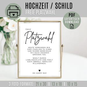 Puede incluir: Un letrero blanco enmarcado con texto negro, que incluye las palabras "Platzwahl" y "Oh Happy Day". El letrero está en un marco dorado e incluye el texto "HOCHZEIT / SCHILD" y "FREIE PLATZWAHL". El letrero está disponible en 3 formatos de foto: 21 x 30 cm, 13 x 18 cm y 10 x 15 cm.
