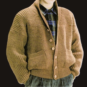 Può includere: Un cardigan di maglia marrone con collo a scialle e sei bottoni sul davanti. Il cardigan ha due tasche a toppa sul davanti e una trama a coste.