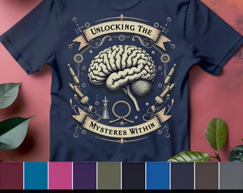 May include: A navy blue t-shirt with a vintage-style illustration of a brain and the text "Unlocking the Mysteries Within". The shirt is available in 10 different colors.