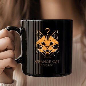 Orange Cat Energy Mug: Playful Feline Design, Black Ceramic Coffee Cup