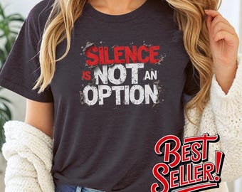 May include: A dark gray t-shirt with a white graphic that says "Silence is not an option".