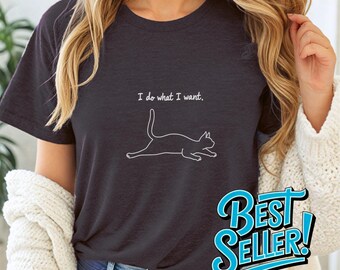 May include: A dark gray t-shirt with the text "I do what I want." and a white outline of a cat stretching. The shirt is a best seller.