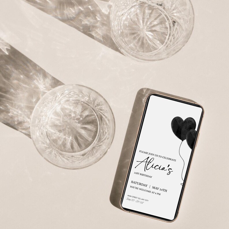 May include: A smartphone displaying a digital birthday invitation with black heart-shaped balloons. The text reads: Please join us to celebrate Alicia's 21st birthday, Saturday, May 14th, you're welcome at 8 PM, Main Street 123, Any City, RSVP 000-123-4567.